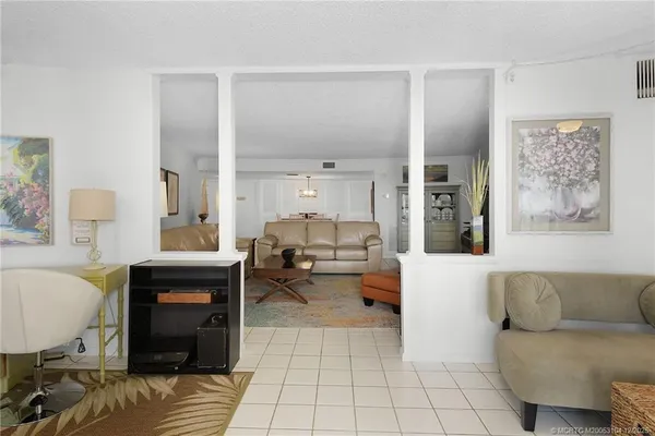 a spacious bedroom with a bed and dresser