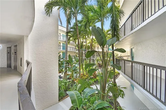 a living room with furniture and floor to ceiling window