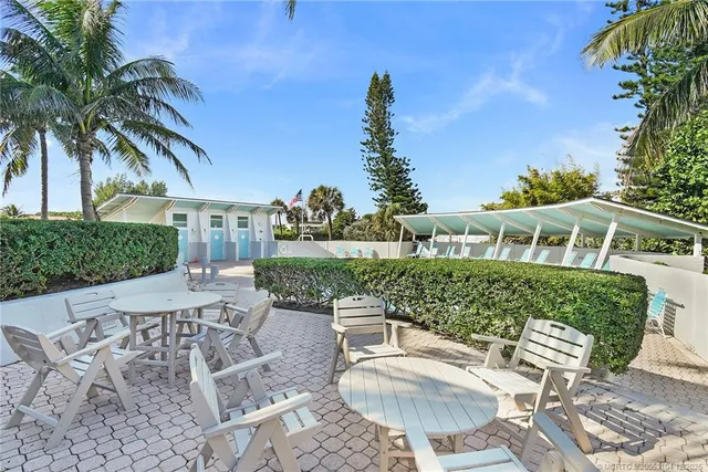 a view of a wooden house with a sink and a yard