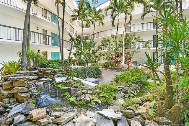 a living room with furniture a couch and a dresser with wooden floor