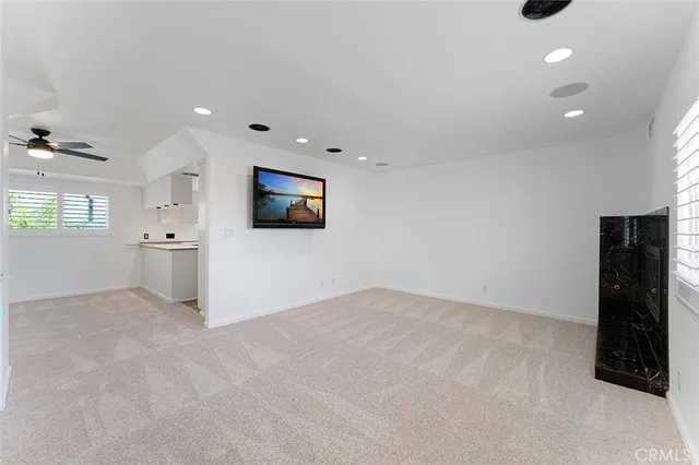 an empty room with a empty space and windows