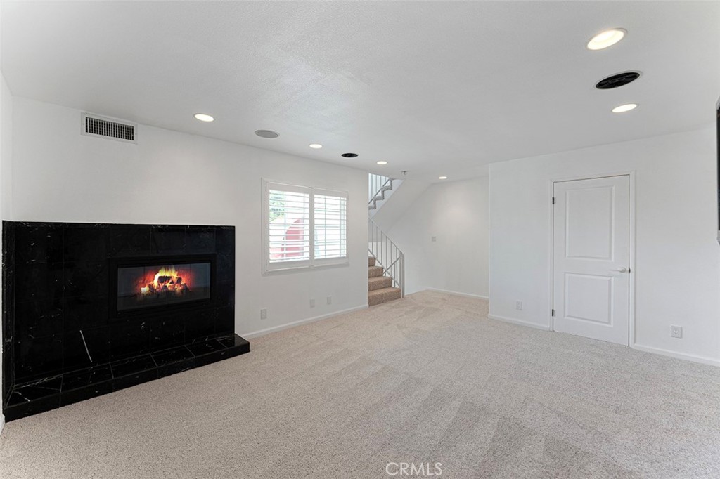 13036 Springarden Lane Westminster, CA 92683 - Photo 13 of 41 a view of an empty room with a fireplace and a window
