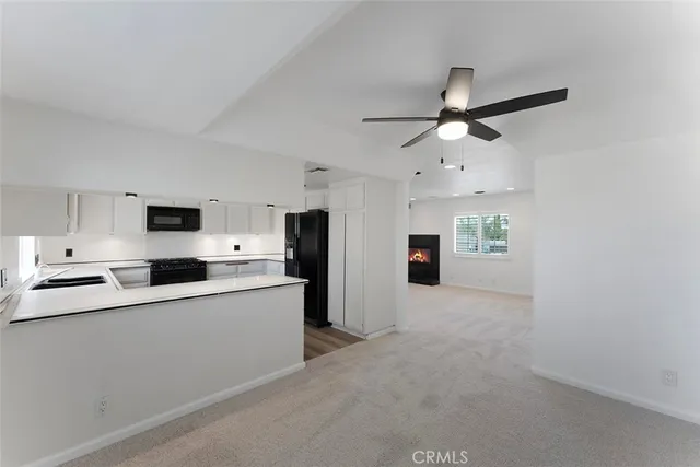 a kitchen with stainless steel appliances a refrigerator sink and microwave