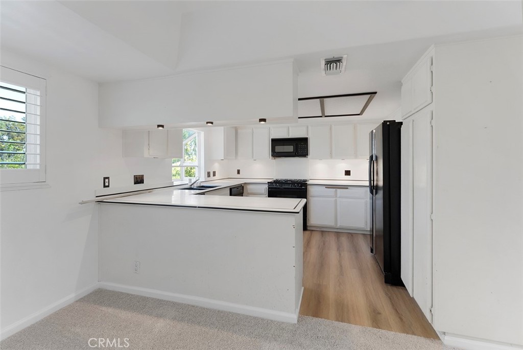 13036 Springarden Lane Westminster, CA 92683 - Photo 17 of 41 a kitchen with stainless steel appliances a refrigerator sink and microwave