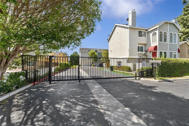 an aerial view of a house with a yard and a large tree