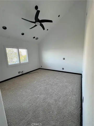 a view of a room with a ceiling fan