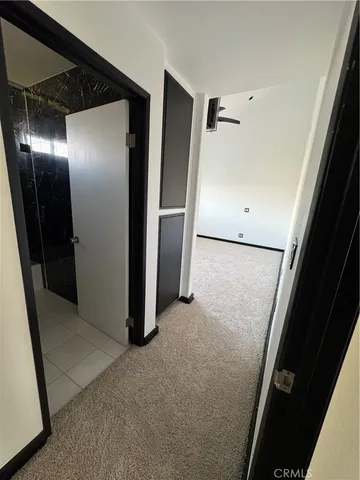 a view of a livingroom with wooden floor and cabinet