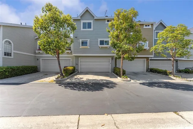 a view of a house with a yard and street
