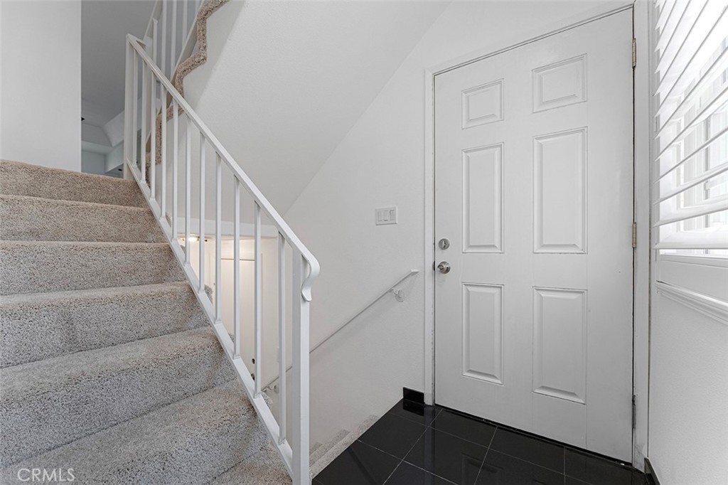 13036 Springarden Lane Westminster, CA 92683 - Photo 10 of 41 a view of staircase with lots of frames on wall and stairs