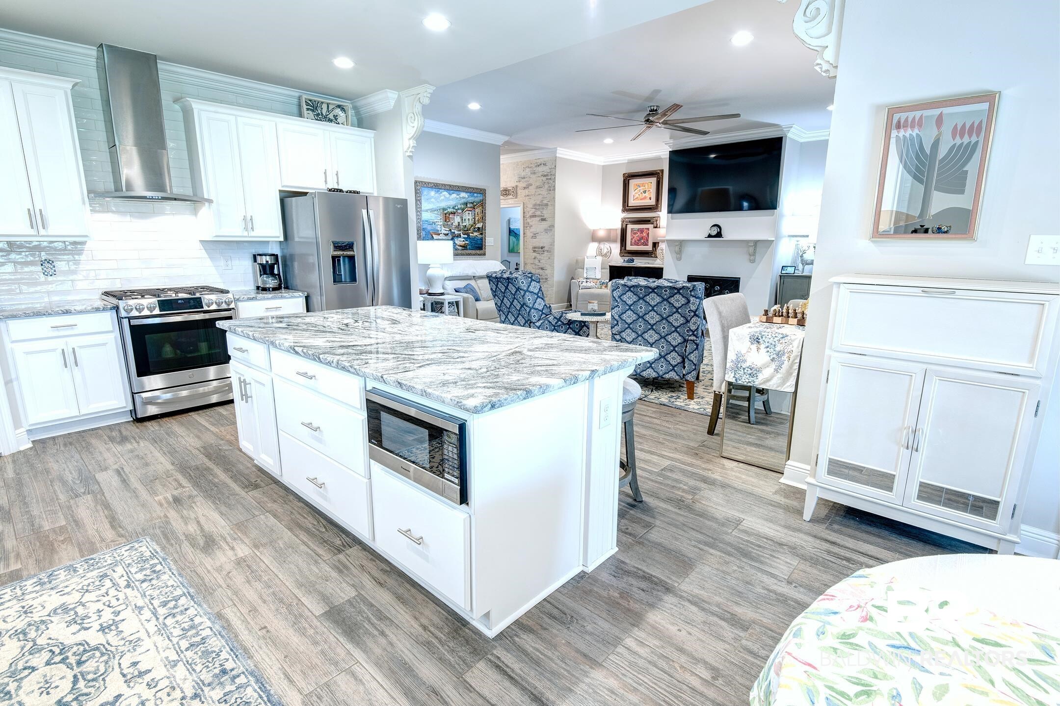 9988 Dunleith Loop Daphne, AL 36526 - Photo 51 of 51 Kitchen featuring added stainless steel appliances, ceiling fan, tasteful backsplash, wall chimney exhaust hood, and light wood-type flooring