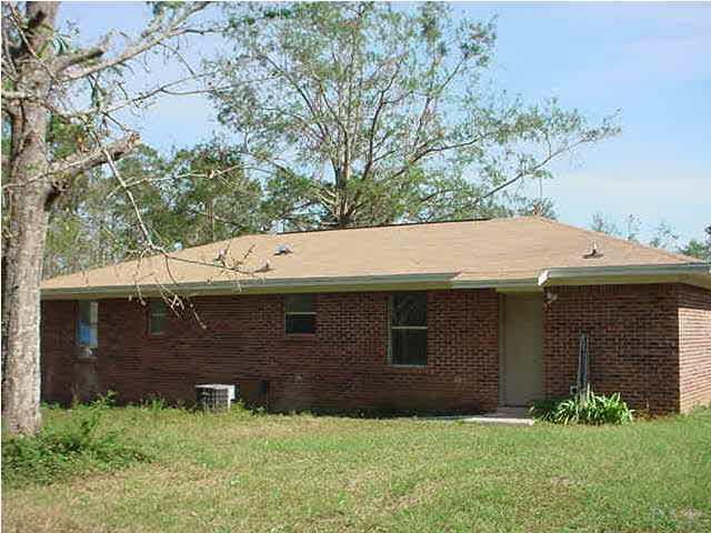 175 Navarro Road Cantonment, FL 32533 - Photo 3 of 7 a view of a house with a yard