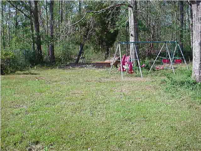 175 Navarro Road Cantonment, FL 32533 - Photo 4 of 7 a view of backyard with trampoline