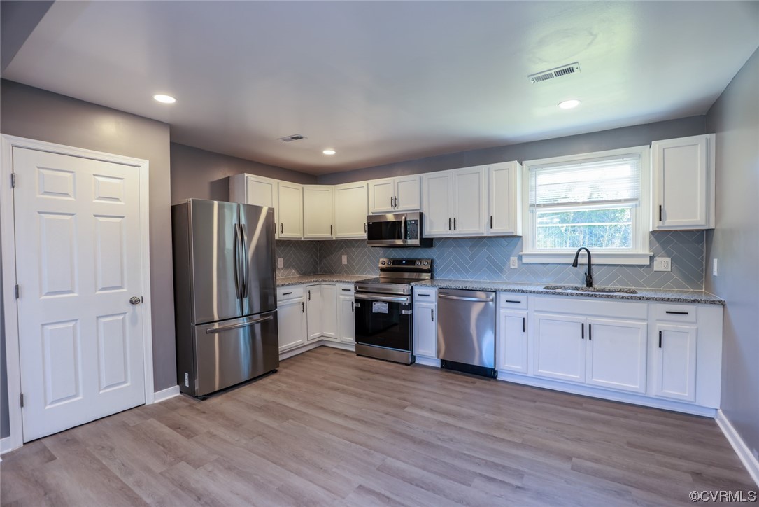 3309 Croydon Road Richmond, VA 23223 - Photo 7 of 21 Kitchen with light stone counters, light hardwood