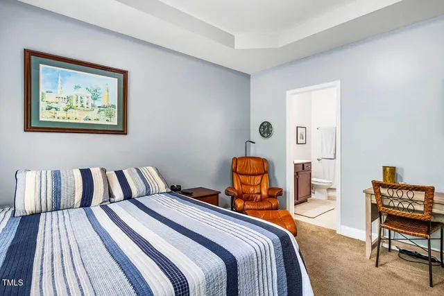 a bedroom with a bed chair and window