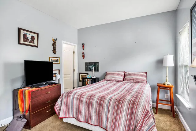 a view of a chair and table in backyard of the house
