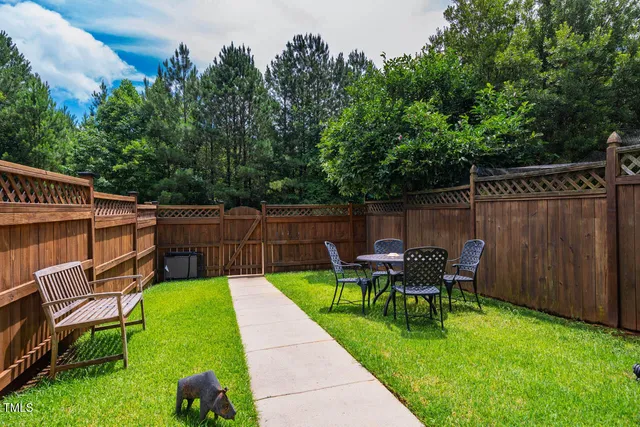 a view of a house with a large window and wooden fence