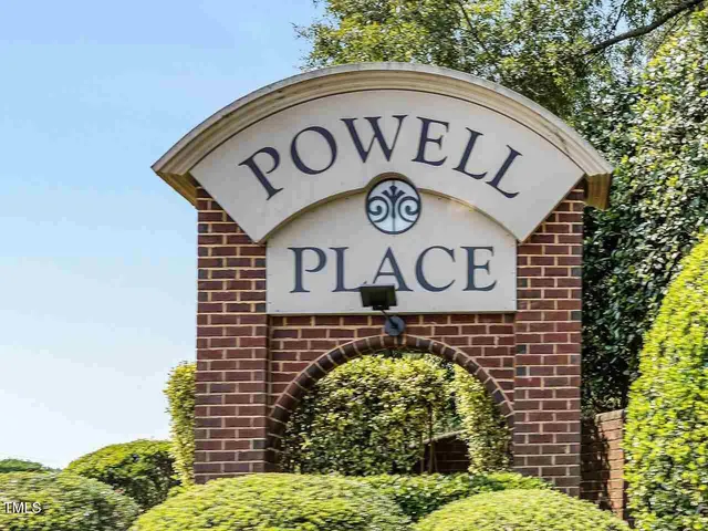a view of a patio with a table and chairs under an umbrella