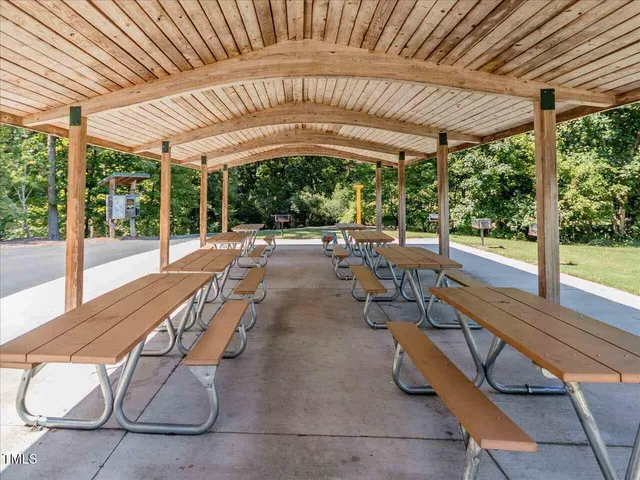 a view of a grassy field with trees in the background