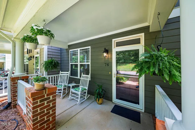 front view of a brick house with a yard
