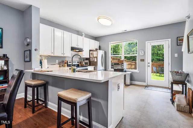 a kitchen with stainless steel appliances a refrigerator and a stove