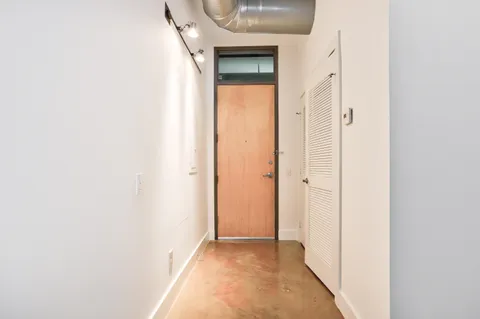 a view of a hallway with wooden floor