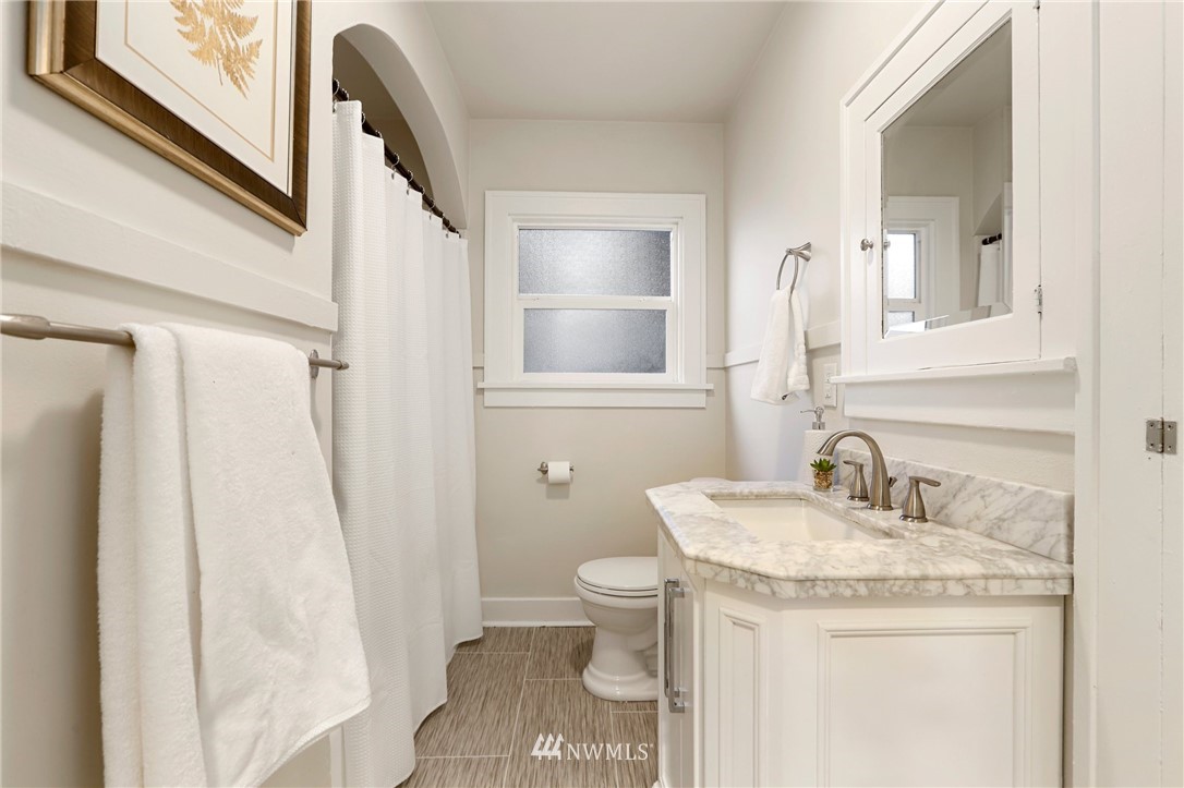 5431 Broadway Everett, WA 98203 - Photo 12 of 22 a bathroom with a granite countertop sink toilet and shower