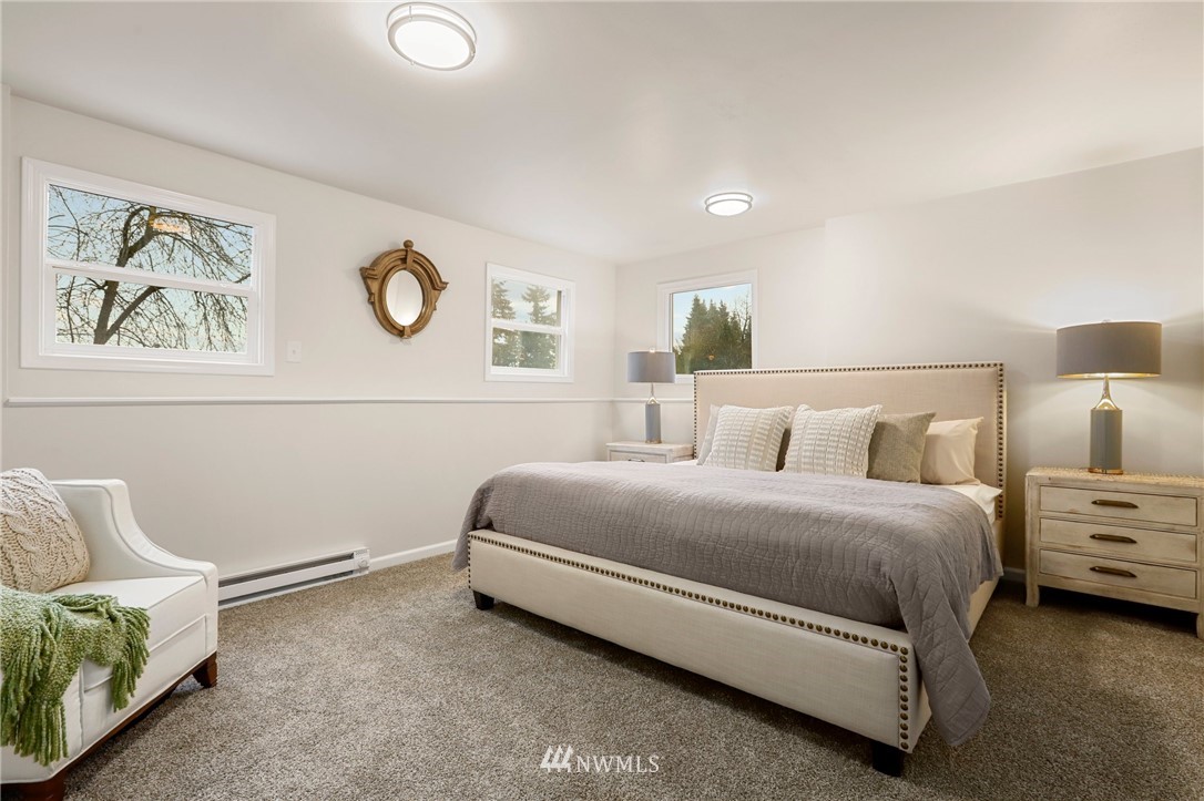 5431 Broadway Everett, WA 98203 - Photo 16 of 22 a spacious bedroom with a bed and painting on the wall