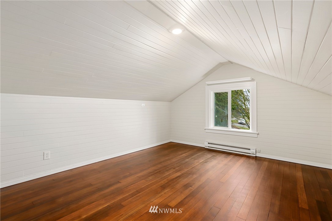 5431 Broadway Everett, WA 98203 - Photo 19 of 22 an empty room with wooden floor and windows