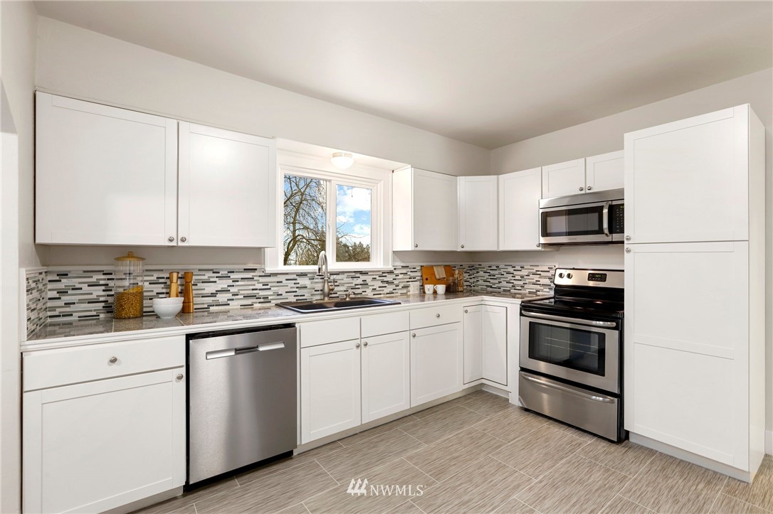 5431 Broadway Everett, WA 98203 - Photo 9 of 22 a kitchen with granite countertop cabinets stainless steel appliances and a sink
