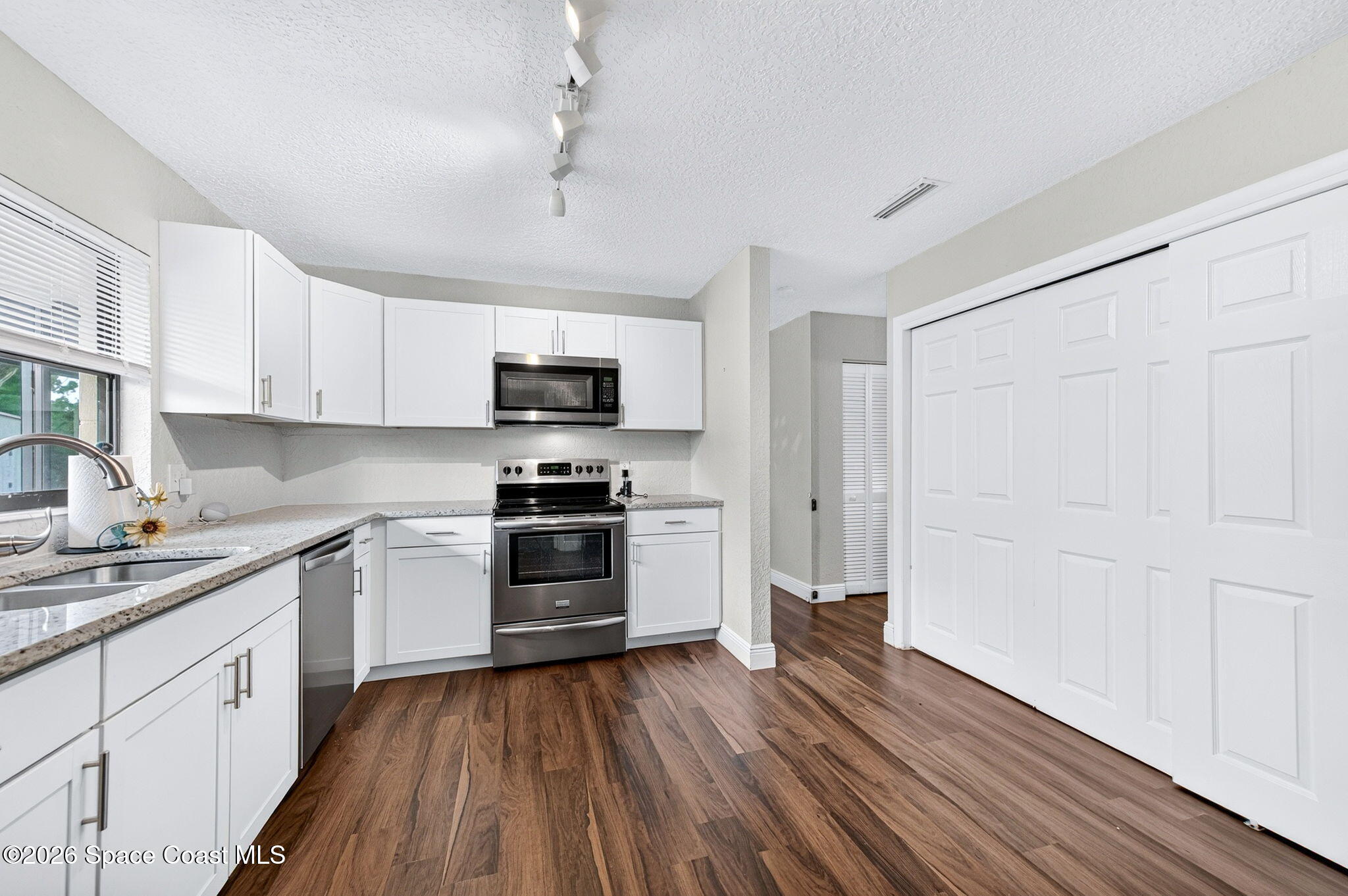 996 Botany Lane Rockledge, FL 32955 - Photo 15 of 35 a kitchen with wooden floors and appliances