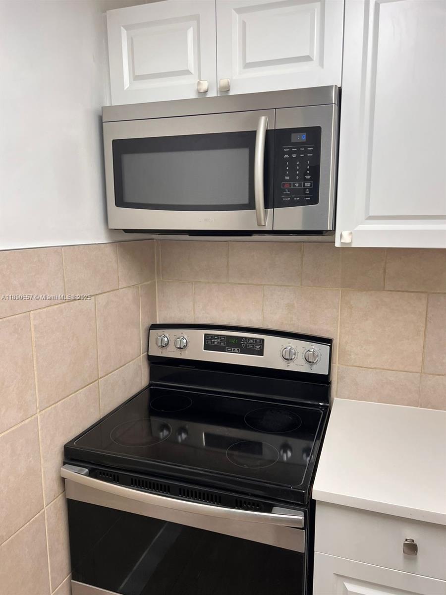 271 Bonnie Boulevard, Unit 205 Palm Springs, FL 33461 - Photo 2 of 12 a stove top oven sitting inside of a kitchen