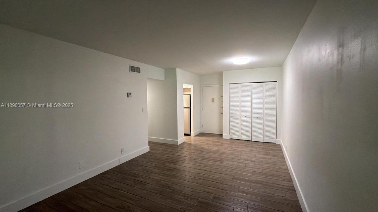 271 Bonnie Boulevard, Unit 205 Palm Springs, FL 33461 - Photo 8 of 12 a view of an empty room with wooden floor