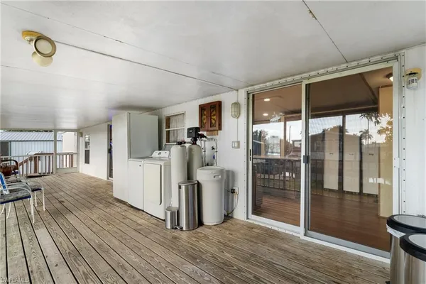 a view of a living room hardwood floor and a kitchen