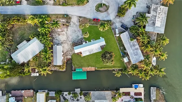 an aerial view of a house with a yard