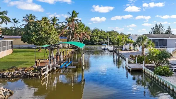 a view of a lake with a house swimming pool and outdoor space