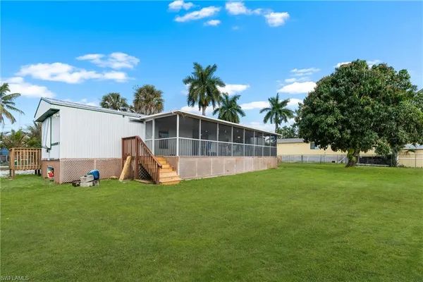 a view of a backyard with a garden and entertaining space