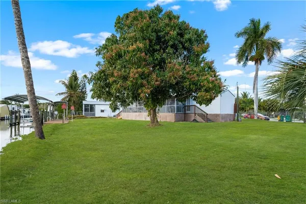 a view of a trees and barn in the back yard