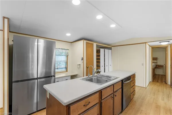 a kitchen with stainless steel appliances a refrigerator and a sink