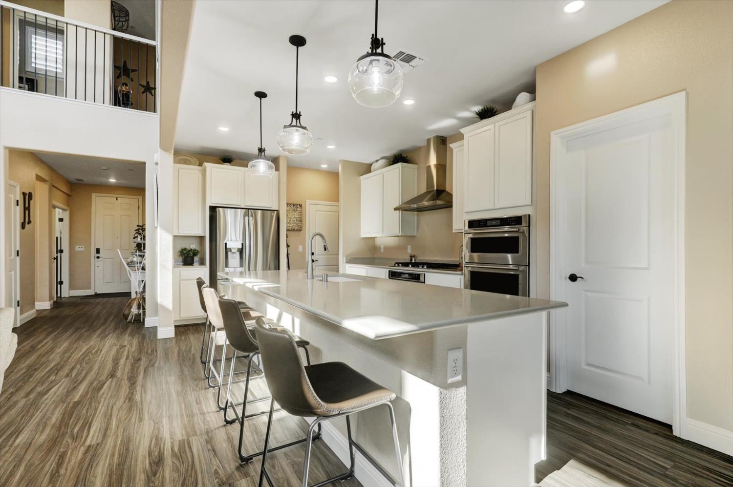 1104 Shadowgate Drive Roseville, CA 95747 - Photo 12 of 41 a kitchen with stainless steel appliances a dining table chairs stove and refrigerator
