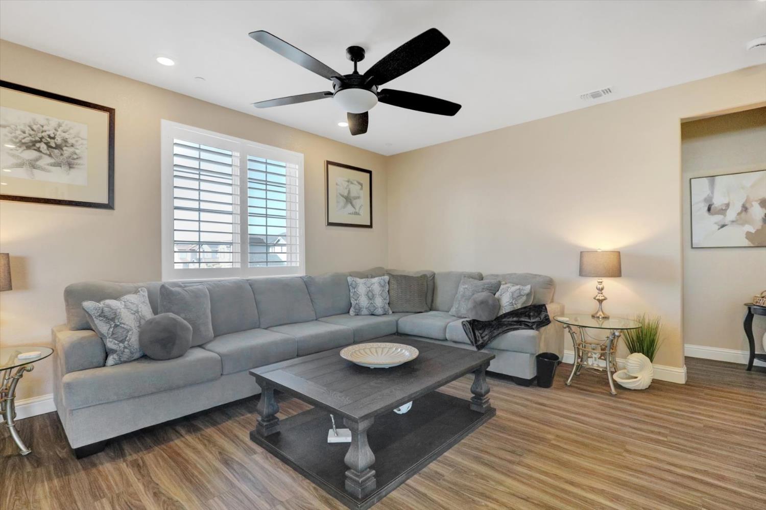 1104 Shadowgate Drive Roseville, CA 95747 - Photo 16 of 41 a living room with furniture and a wooden floor
