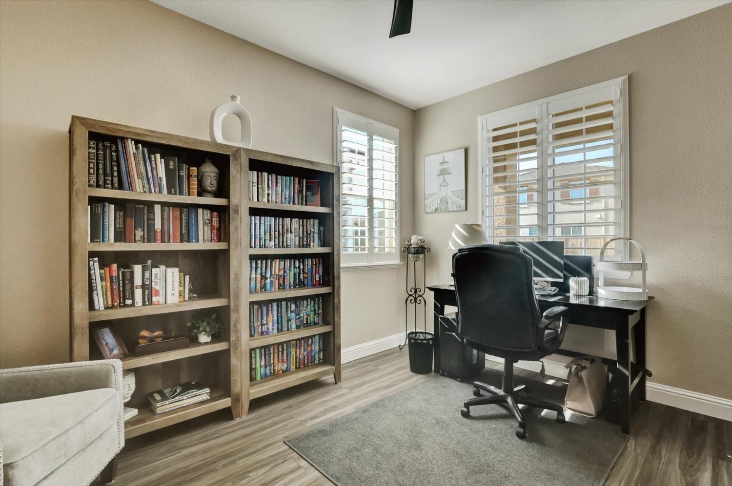 1104 Shadowgate Drive Roseville, CA 95747 - Photo 18 of 41 a view of a workspace with furniture and a bookshelf
