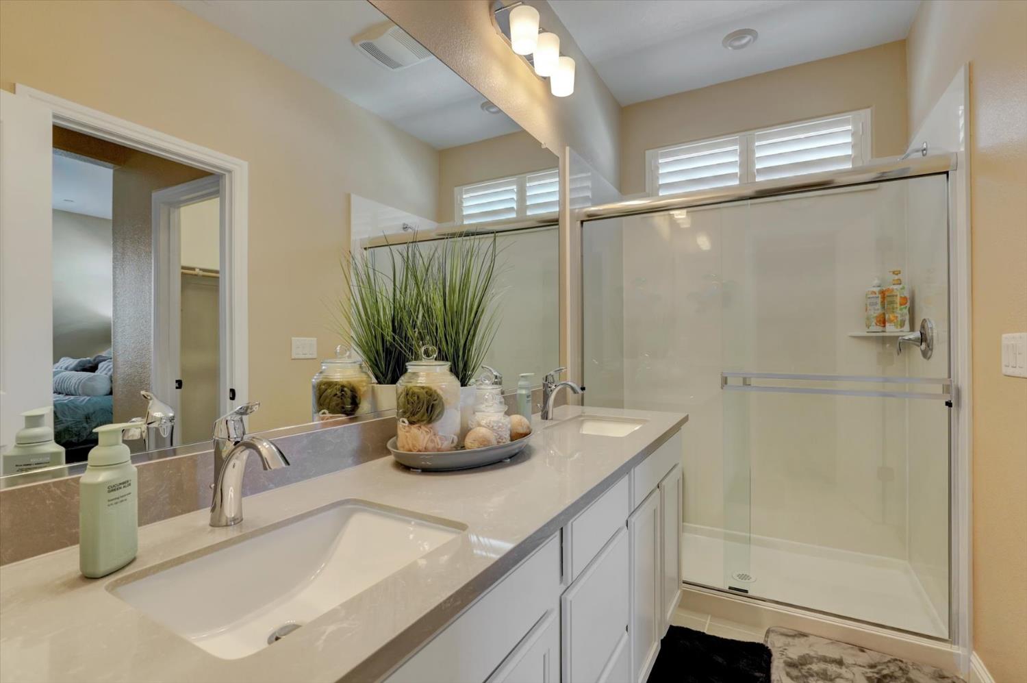 1104 Shadowgate Drive Roseville, CA 95747 - Photo 21 of 41 a bathroom with a double vanity sink a mirror and shower