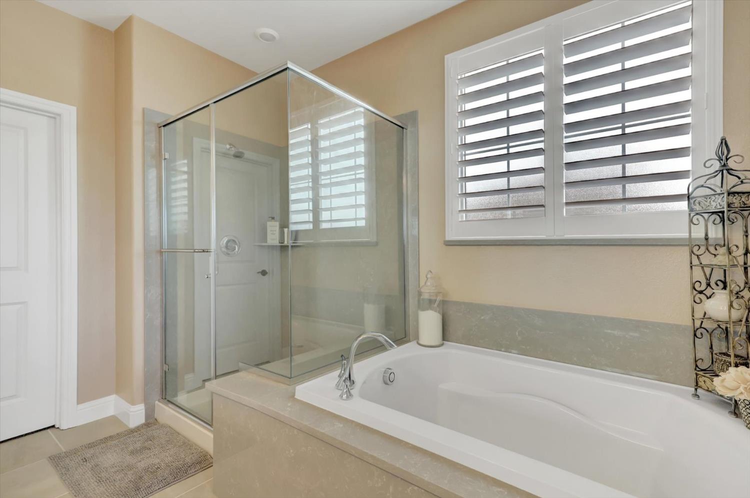 1104 Shadowgate Drive Roseville, CA 95747 - Photo 26 of 41 a bathroom with a bathtub and a shower