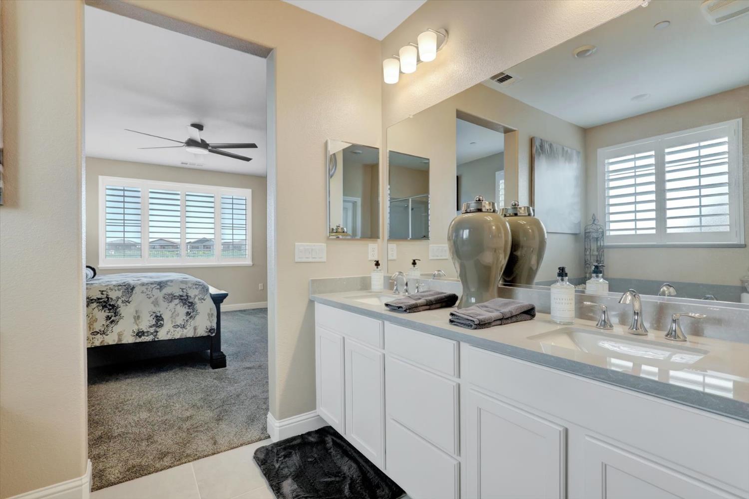 1104 Shadowgate Drive Roseville, CA 95747 - Photo 27 of 41 a en suite bathroom with double sink and mirror