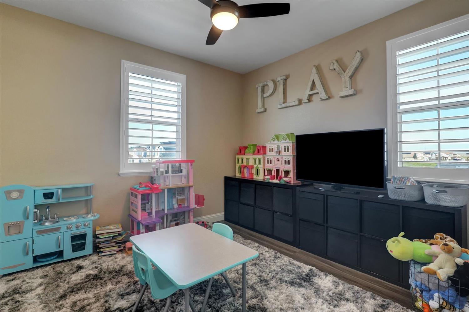 1104 Shadowgate Drive Roseville, CA 95747 - Photo 33 of 41 a living room with furniture and a flat screen tv