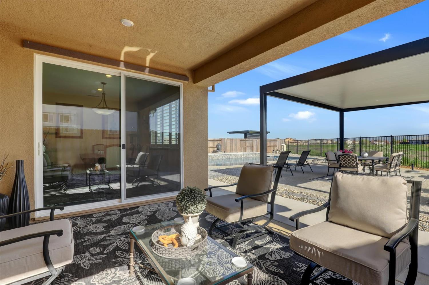 1104 Shadowgate Drive Roseville, CA 95747 - Photo 34 of 41 a patio with a table and chairs under an umbrella