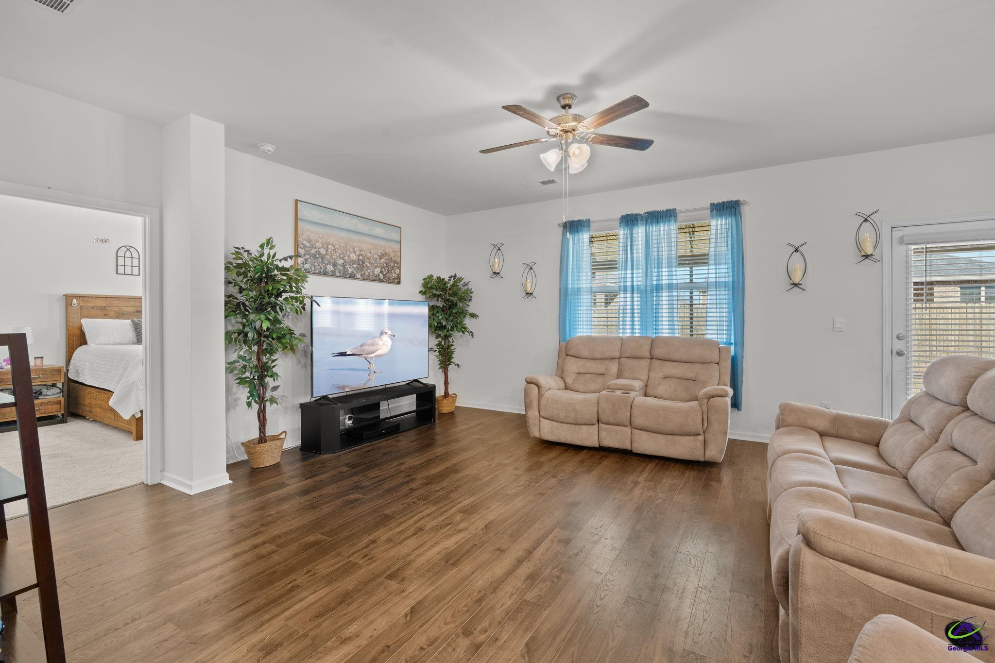 134 Farmers Way Perry, GA 31069 - Photo 27 of 47 a living room with furniture and a wooden floor