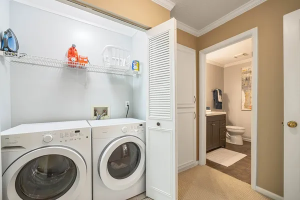 a view of a hallway with washer and dryer