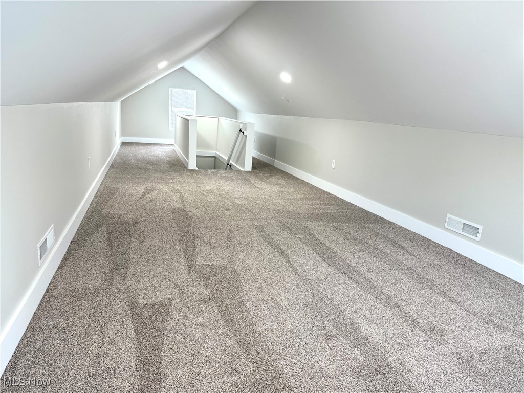 4670 Sandy Lake Road Ravenna, OH 44266 - Photo 23 of 26 Additional living space featuring baseboards, visible vents, and carpet flooring