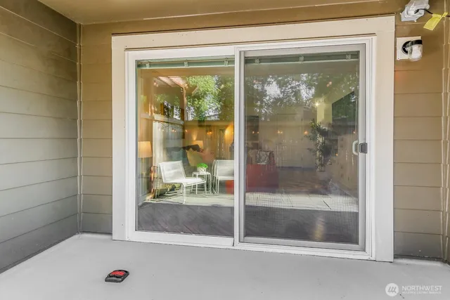 a bathroom with a glass shower door and a window